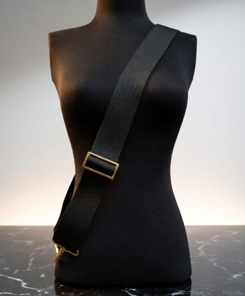 Extra wide, guitar-style strap for handbags and purses. Soft and thick nylon material with heavy duty hardware. Adjustable from shoulder to cross body positions. Colors from black, brown, navy, fuchsia, red, blue and more. Shown on a mannequin.