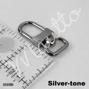 Silver-tone clip for leather wrist strap.
