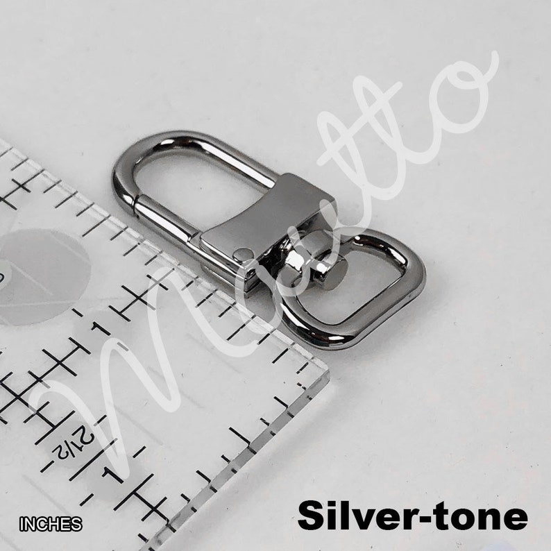 Silver-tone clip for leather wrist strap.