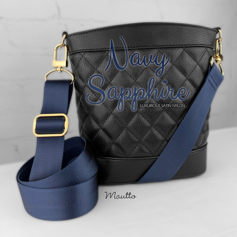Photo of navy woven purse strap on purse. Adjustable shoulder to cross body length.