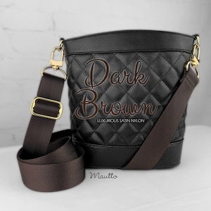 Photo of dark brown woven purse strap on purse. Adjustable shoulder to cross body length.