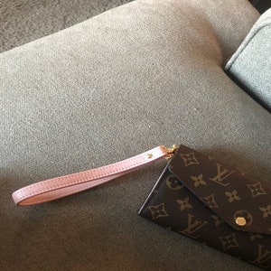 Photo provided by customer showing Pink Blush leather wrist strap attached to accessory wallet.