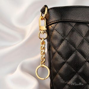 Gold purse accessory to tether keys safely to your bag. Includes keyring and swivel clip.