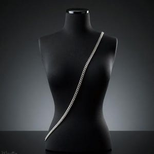 Silver fancy link chain straps for purses, handbags of all sizes and styles and phone cases. Shown on a mannequin in the cross body style.