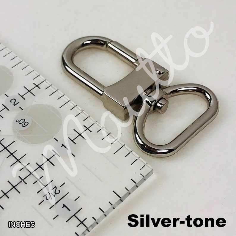 Silver-tone U-shape swiveling clip for short shoulder leather straps.