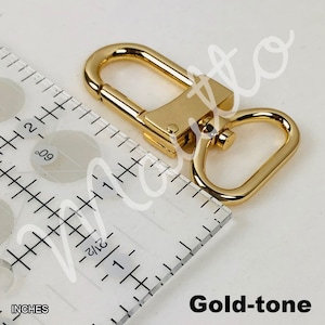 Gold-tone U-shape swiveling clip for short shoulder leather straps.