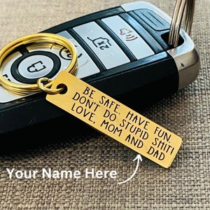 May include: Gold-toned keychain with a metal tag that reads "Have Fun. Be Safe. Don't Do Stupid Shit! Love, Mom and Dad".