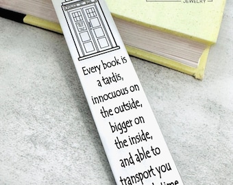 May include: A silver metal bookmark with a blue tassel. The bookmark features a black and white illustration of a police box and the text: "Every book is a tardis, innocuous on the outside, bigger on the inside, and able to transport you through time and space."