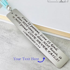 personalized bible verse bookmark engraved with custom scripture on stainless steel metal bookmark with leather tassel, christian bookmark gift displayed inside open Bible with permanent laser engraved verse detail