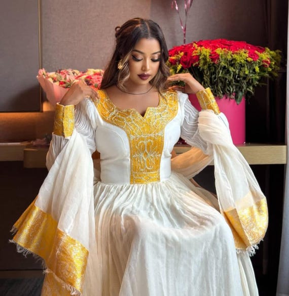 Habesha Dress - Elegant White Cotton with Gold Borders for Ethiopian and Eritrean Celebrations Habesha Dress - Elegant White Cotton with Gold Borders for Ethiopian and Eritrean Celebrations