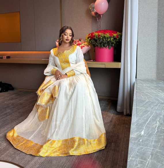 Habesha Dress - Elegant White Cotton with Gold Borders for Ethiopian and Eritrean Celebrations Habesha Dress - Elegant White Cotton with Gold Borders for Ethiopian and Eritrean Celebrations