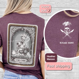 May include: Heather maroon t-shirt with a vintage illustration of a skeleton chef on the back. The front of the shirt has a white skull wearing a chef's hat with crossed knives and the text "NAME HERE".