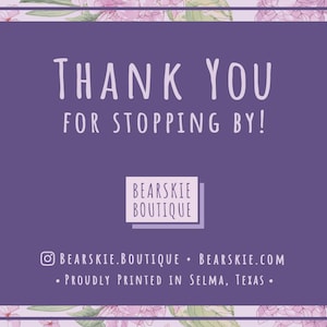 May include: Purple thank you card with white text that says "Thank You for Stopping By!" and the name of the shop "Bearskie Boutique" in a white box. The card has a floral border with pink and green flowers.