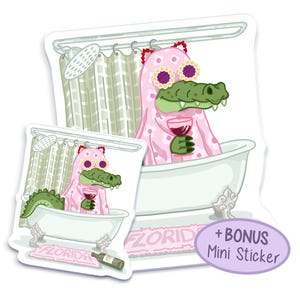 May include: Two sticker designs featuring a cartoon alligator wearing a pink bathrobe and sunglasses, holding a glass of wine and relaxing in a bathtub. The text "FLORIDA" is on a pink bath mat. The smaller sticker has a bonus mini sticker.