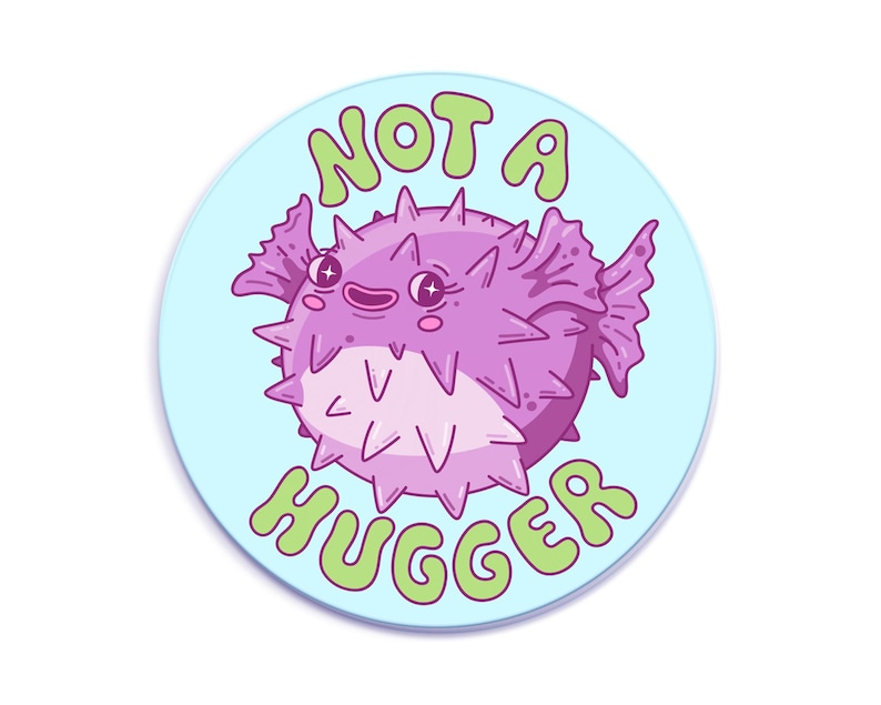 A cute and spiky purple puffer fish with the text "Not a Hugger" in bubbly green letters on a light blue background.