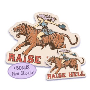 A vintage-style sticker featuring a fierce cowgirl riding a tiger with the phrase "Raise Hell" in bold red text, perfect for retro and feminist aesthetics. Double Sticker Pack.