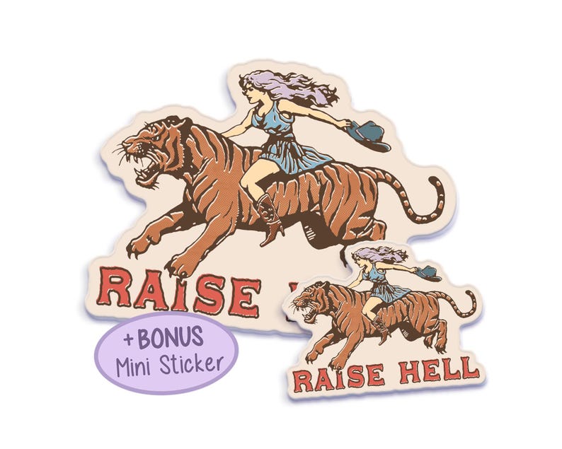 A vintage-style sticker featuring a fierce cowgirl riding a tiger with the phrase "Raise Hell" in bold red text, perfect for retro and feminist aesthetics. Double Sticker Pack.