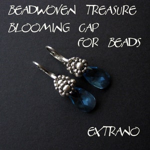May include: A pair of silver earrings with blue teardrop-shaped crystals. The earrings feature a beaded design and are labeled "Beadwoven Treasure Blooming Cap for Beads Extraño".