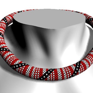 May include: A red, white, and black beaded necklace with a geometric pattern. The necklace is made of small, round beads and is worn on a mannequin.