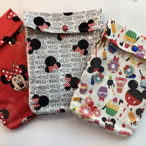 May include: A white ceramic mug with a black handle and the text "But First, Coffee" in a bold, black font. The mug is set against a neutral background, highlighting its simple design.