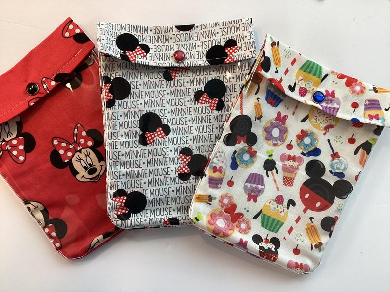 May include: A white ceramic mug with a black handle and the text "But First, Coffee" in a bold, black font. The mug is set against a neutral background, highlighting its simple design.