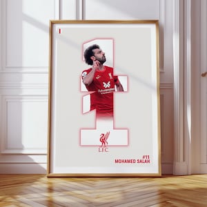 May include: A white poster with a red number one, a red Liverpool Football Club crest, and a photo of Mohamed Salah in a red Liverpool jersey. The text on the poster reads "#11 MOHAMED SALAH".