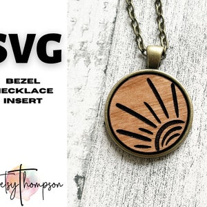 May include: A wooden sun pendant necklace with a brown chain. The pendant is a circle with a sun design in black. The pendant is on a white background.