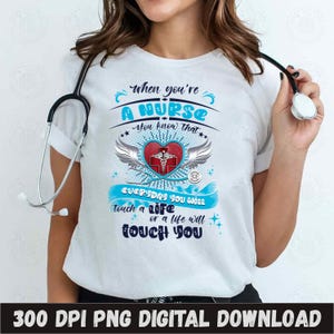 May include: A white t-shirt with a blue and red graphic design that says "When you're a nurse you know that everyday you will touch a life or a life will touch you". The graphic includes a red heart with a medical symbol and wings.