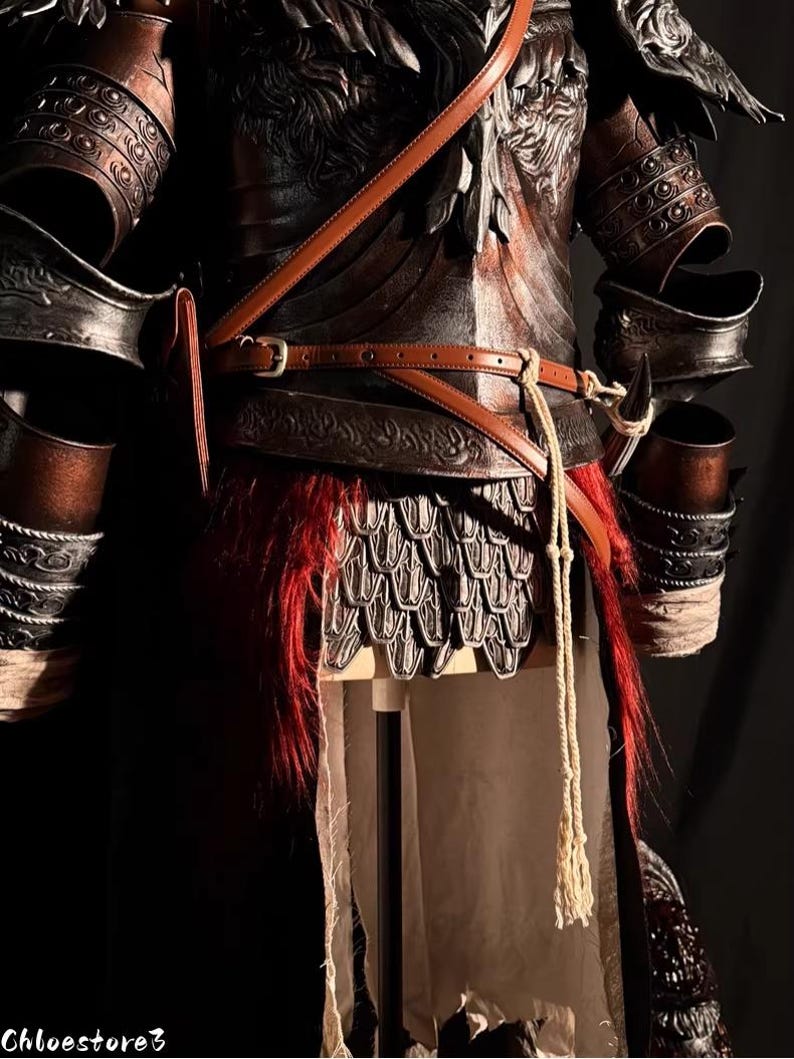 May include: Close-up of a detailed, dark brown and black medieval armor set. The armor features intricate embossed designs, leather straps, and a red fur-like accent. The image includes the text "Chloestore3".