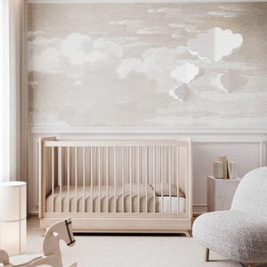 May include: A nursery with a light wood cot and a rocking horse. The room features a neutral colour scheme, cloud wallpaper, and a white rug. A white armchair and a floor lamp are also visible. The room has a calming atmosphere.