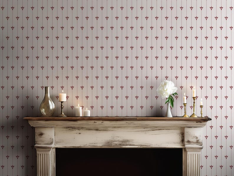 May include: A fireplace mantel with candles, a vase, and a white flower arrangement. The wall behind the mantel is covered in wallpaper with a repeating pattern of vertical lines and burgundy floral accents.