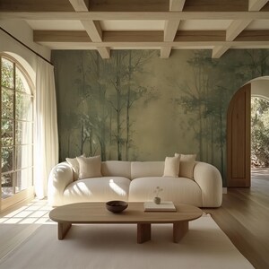 May include: A light beige sectional sofa with a wood coffee table in a living room with a large window and a wall mural of a forest scene.