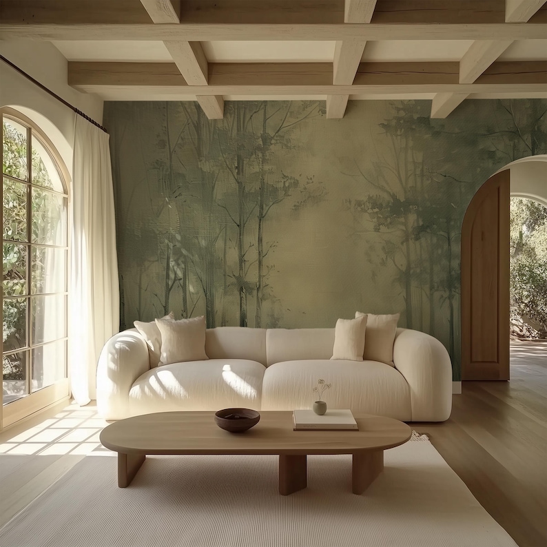 May include: A light beige sectional sofa with a wood coffee table in a living room with a large window and a wall mural of a forest scene.