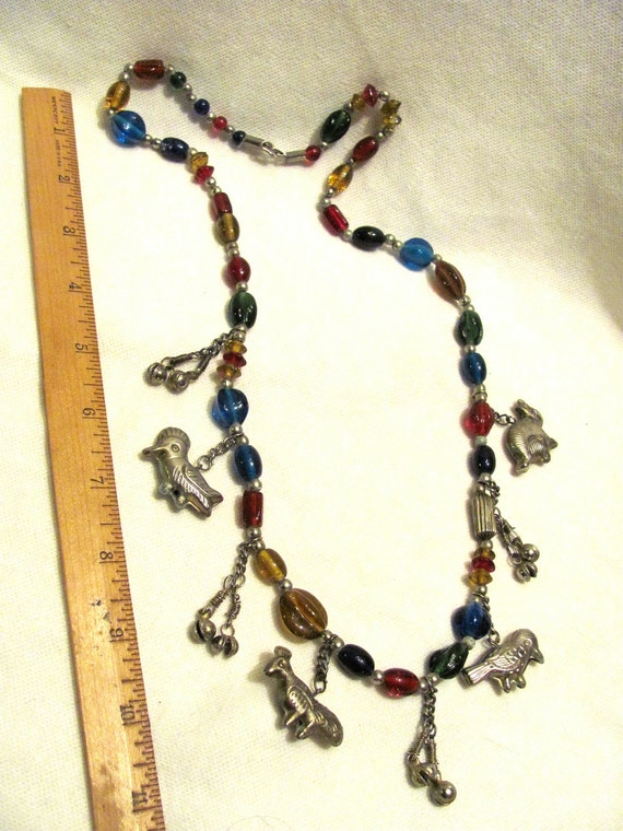 Colorful Necklace with glass beads and silver animal fetishes and bells