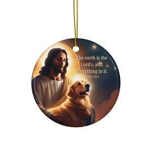 May include: A round ceramic ornament featuring a painting of Jesus holding a golden retriever. The background is a starry night sky with a crescent moon. The text "The earth is the Lord's, and everything in it. Psalm 24:1" is printed on the ornament.