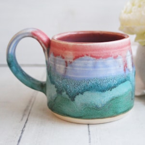 May include: A set of three ceramic mugs with a speckled, matte finish. The mugs are in shades of cream, light gray, and dark gray. Each mug has a simple, minimalist design, perfect for coffee or tea.