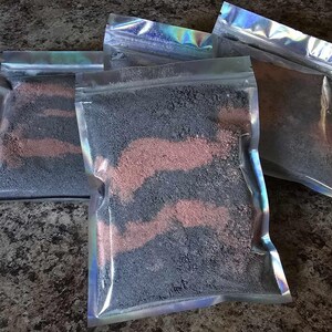 Puede incluir: Cuatro bolsas de plástico transparentes llenas de sales de baño negras y rosas. Las bolsas están selladas y tienen un acabado holográfico iridiscente.