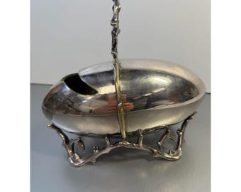 Azucarero victoriano de plata chapada en huevos de Martin, Hall & Co. sobre soporte rústico de ramas.