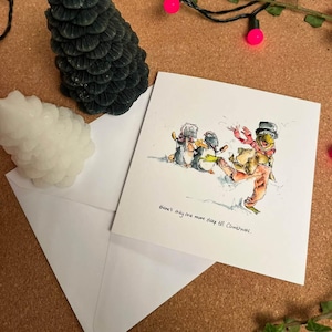 May include: A Christmas card featuring a hand-drawn illustration of penguins in the snow. The text on the card reads "There's only one more sleep till Christmas."