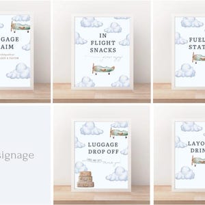 May include: Set of six 8x10 inch framed signs with a vintage airplane and cloud theme. Each sign has a different phrase: Baggage Claim, In Flight Snacks, Fueling Station, Luggage Drop Off, and Layover Drinks.