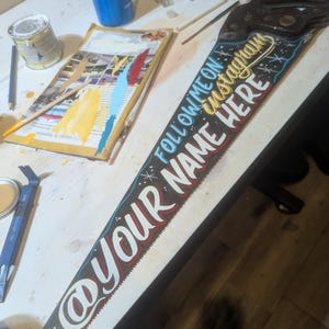Custom painted saw with name and tag