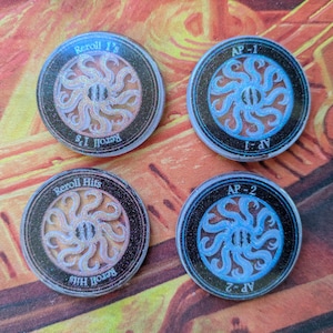 May include: Four circular game tokens with a black border and a central design of swirling tentacles. Two tokens read "Reroll 1's" and two read "Reroll Hits". The other two tokens read "AP-1" and "AP-2".