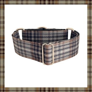May include: A grey and navy plaid dog collar with silver-colored metal hardware. The collar features a classic tartan pattern with white and brown accents. The collar is designed for comfort and style.