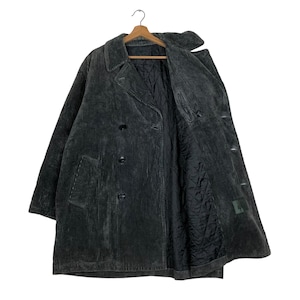 May include: A dark gray corduroy coat with a double-breasted design. The coat features a notched collar, two front pockets, and a quilted black lining. The coat is hanging on a wooden hanger.