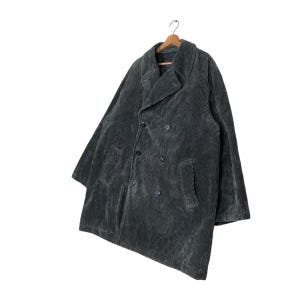 May include: A dark gray corduroy coat with a double-breasted design. The coat has a notched collar, two front pockets, and a button closure. The coat is hanging on a wooden hanger.