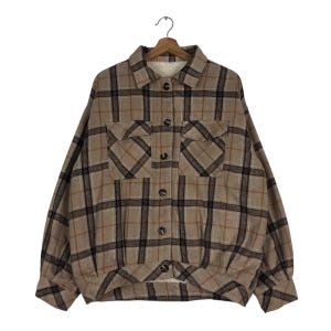May include: A brown and black checked flannel shirt with a sherpa lining. The shirt has two large pockets on the front and a button-up closure.