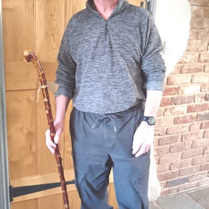 May include: A distressed wooden sign, inscribed with "Welcome to our home" in white. The sign has a rustic appearance, ideal for adding a welcoming touch to any entrance.