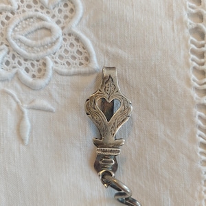 May include: A set of three ceramic mugs with a speckled, matte finish. Each mug features a different color: light blue, cream, and gray. The mugs have a simple, modern design with a rounded shape and a comfortable handle.