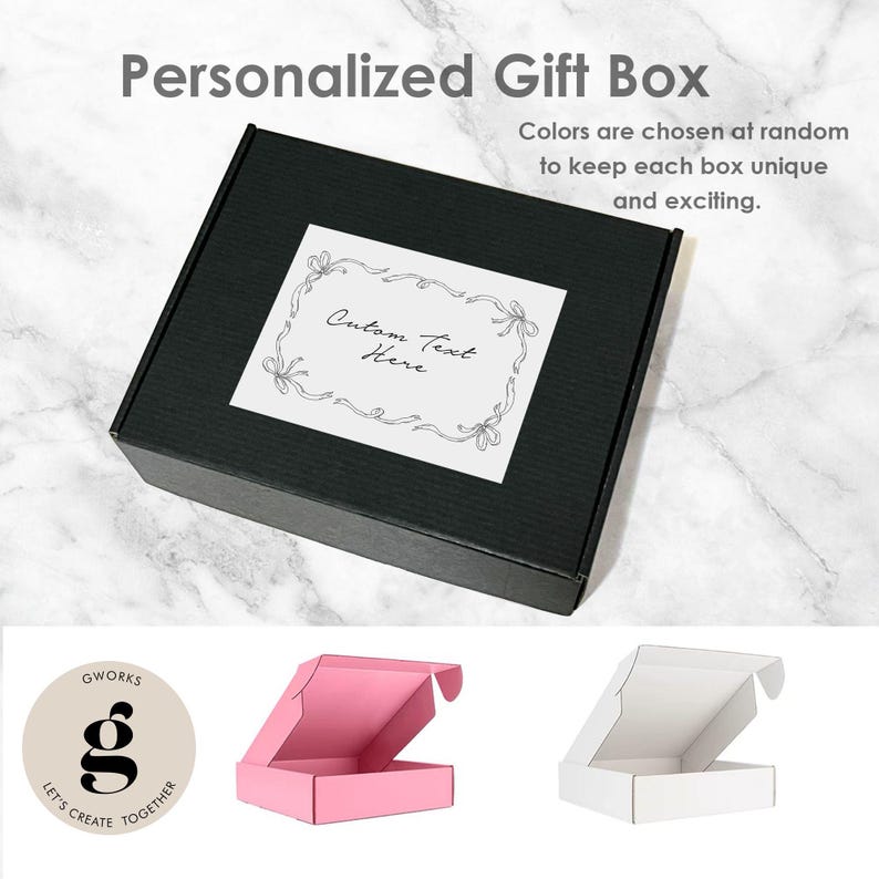 May include: A black gift box with a white label that reads "Custom Text Here" inside a decorative border. The text "Personalized Gift Box" and "Colors are chosen at random to keep each box unique and exciting" are also visible.