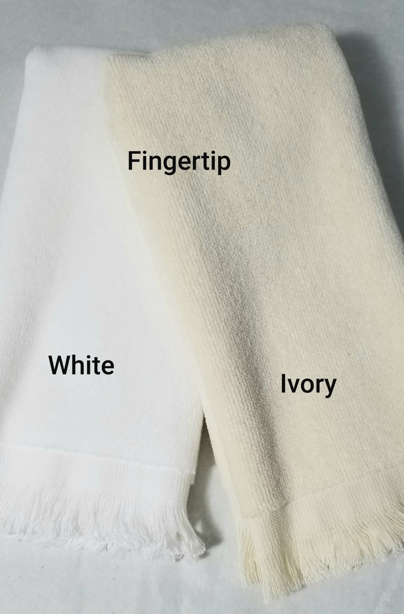 May include: Two towels, one white and one ivory, with fringed edges. The towels are labeled "White", "Ivory", and "Fingertip".